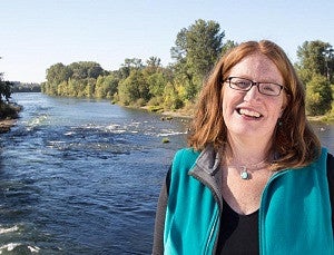 Adell Amos standing in front of the Willamette River Adell Amos standing in front of the Willamette River