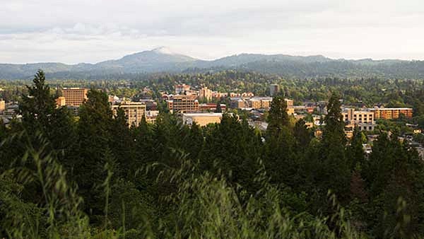 Eugene, Oregon Skyline of Eugene with trees in the foreground and hills in the background
