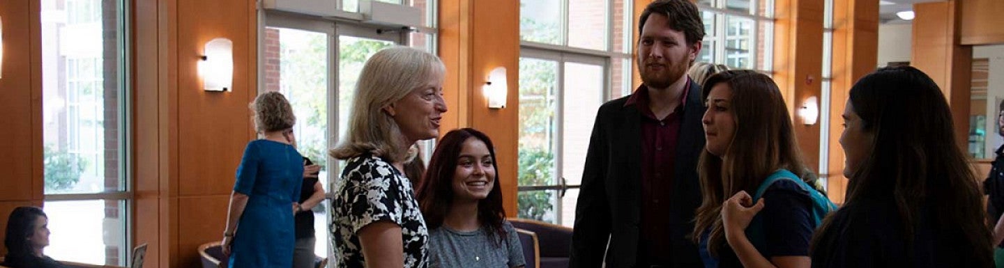 Suzanne Rowe talking with students in the Knight Law Center